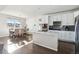Open concept kitchen with white cabinets, an island, and stainless steel appliances at 8086 S Grand Baker Way, Aurora, CO 80016