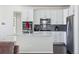 Modern kitchen with white cabinets, a quartz countertop, and stainless steel appliances at 8086 S Grand Baker Way, Aurora, CO 80016
