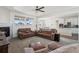 Open living room with leather couches and a view into the kitchen at 8086 S Grand Baker Way, Aurora, CO 80016