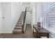 Elegant staircase with a metal railing in a spacious entryway at 8086 S Grand Baker Way, Aurora, CO 80016
