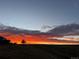 Residential property with a dramatic sunset in the background at 8086 S Grand Baker Way, Aurora, CO 80016