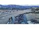 Breathtaking aerial view of the community with winding roads and a stunning mountain backdrop at 4502 Echo Cliff Ln, Larkspur, CO 80118