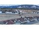 An aerial view of the homes situated in a valley, with a backdrop of snow-capped mountains at 4502 Echo Cliff Ln, Larkspur, CO 80118