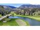 Overhead view of lakeside golf course, showcasing the manicured greens and lake scenery at 4502 Echo Cliff Ln, Larkspur, CO 80118