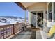 Relaxing outdoor balcony with comfortable seating, offering scenic views of the mountains at 4502 Echo Cliff Ln, Larkspur, CO 80118