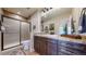 Bathroom with a sliding glass shower door, a single sink vanity, and tile flooring at 4502 Echo Cliff Ln, Larkspur, CO 80118