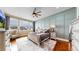 Spacious bedroom with a ceiling fan, large windows and board and batten accent wall at 4502 Echo Cliff Ln, Larkspur, CO 80118