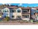 Multi-level home featuring balconies, stone accents, and landscaped backyard at 4502 Echo Cliff Ln, Larkspur, CO 80118