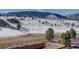 Scenic view of the landscape featuring trees and snow, with a rustic fence in the foreground at 4502 Echo Cliff Ln, Larkspur, CO 80118
