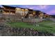 Upscale community featuring well-maintained landscaping, stone walls, and multiple-story buildings at 4502 Echo Cliff Ln, Larkspur, CO 80118