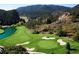 Scenic golf course view featuring lush green fairway and a tranquil pond surrounded by nature at 4502 Echo Cliff Ln, Larkspur, CO 80118