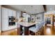 Modern kitchen featuring an island with seating, granite countertops, stainless steel appliances and hardwood floors at 4502 Echo Cliff Ln, Larkspur, CO 80118
