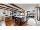 Open-concept kitchen with a large island, modern appliances, and hardwood floors at 4502 Echo Cliff Ln, Larkspur, CO 80118