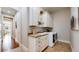 Well-organized laundry room with cabinets, counter space, a sink, and modern washer/dryer units at 4502 Echo Cliff Ln, Larkspur, CO 80118