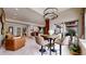 Open-concept living room featuring a unique antler chandelier and seamless access to the outdoor patio at 4502 Echo Cliff Ln, Larkspur, CO 80118