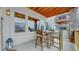 Covered patio with views featuring an outdoor dining area, stone pillars, and wood beams at 4502 Echo Cliff Ln, Larkspur, CO 80118