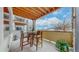 Outdoor patio with a wood ceiling, mountain views, and wooden table and chairs at 4502 Echo Cliff Ln, Larkspur, CO 80118