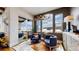 Bright sitting room with stunning views, stylish furniture, antler chandelier, and access to an outdoor patio at 4502 Echo Cliff Ln, Larkspur, CO 80118