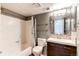 Neutral bath with tiled tub/shower combo and modern vanity with a large mirror at 5250 S Huron Way # 10-207, Littleton, CO 80120