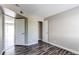 A cozy bedroom featuring hardwood-style floors, a closet, and a view into another room at 5250 S Huron Way # 10-207, Littleton, CO 80120