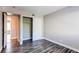 Bedroom showcasing wood-look floors and an open closet for convenient storage at 5250 S Huron Way # 10-207, Littleton, CO 80120