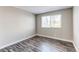 Bright bedroom with wood-look floors and a large window for natural light at 5250 S Huron Way # 10-207, Littleton, CO 80120