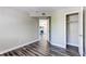 Serene bedroom showcasing an open closet and hardwood-style floors with an inviting view into the living room at 5250 S Huron Way # 10-207, Littleton, CO 80120