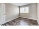 Bright bedroom with stylish wood-look flooring, a neutral color palette, and a window for natural light at 5250 S Huron Way # 10-207, Littleton, CO 80120