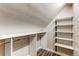 Walk-in closet provides ample storage with custom shelving and hanging racks at 5250 S Huron Way # 10-207, Littleton, CO 80120