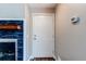 Bright entryway featuring a white door and views of a fireplace with a blue accent at 5250 S Huron Way # 10-207, Littleton, CO 80120