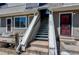 Townhome entrance with stairs leading to multiple units and a red door at 5250 S Huron Way # 10-207, Littleton, CO 80120