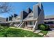 Townhome exterior featuring modern architecture, well-manicured lawn, and inviting entryway at 5250 S Huron Way # 10-207, Littleton, CO 80120