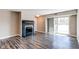 Cozy living room showcasing a fireplace, slider access to balcony, and wood-look flooring at 5250 S Huron Way # 10-207, Littleton, CO 80120
