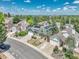 Aerial view of a house with solar panels in a neighborhood with mature trees and a large green space at 778 S Fairplay Ct, Aurora, CO 80012