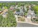 Aerial view of a charming home featuring a solar panel, lush greenery, and detached garage at 778 S Fairplay Ct, Aurora, CO 80012