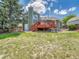 Backyard with a lawn, a wooden fence, and a charming deck with stairs attached to the house at 778 S Fairplay Ct, Aurora, CO 80012
