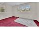 Finished basement with plush red carpeting and bright windows, perfect for a cozy retreat at 778 S Fairplay Ct, Aurora, CO 80012