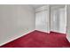 A simple bedroom featuring red carpet, white walls, and white trim for a cozy appeal at 778 S Fairplay Ct, Aurora, CO 80012