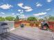 Outdoor deck space with wood floors, a red painted railing, and space for relaxing and entertaining at 778 S Fairplay Ct, Aurora, CO 80012