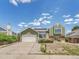 Charming green two-story home with a well-manicured front yard and attached two-car garage at 778 S Fairplay Ct, Aurora, CO 80012