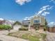 Charming green two-story home with a well-manicured front yard and attached two-car garage at 778 S Fairplay Ct, Aurora, CO 80012