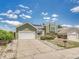 Charming green two-story home with a well-manicured front yard and attached two-car garage at 778 S Fairplay Ct, Aurora, CO 80012