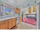 Bright kitchen connected to the living area, featuring wood cabinets and ample counter space at 778 S Fairplay Ct, Aurora, CO 80012