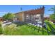 Backyard with a pergola, patio, grill, and storage shed with lush green grass at 7433 Ellingwood Cir, Frederick, CO 80504