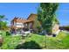 Outdoor living in a lush backyard with pergola-covered patio, and manicured landscaping, perfect for entertaining at 7433 Ellingwood Cir, Frederick, CO 80504