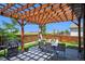 Backyard patio has a dining table and grill perfect for outdoor cooking and entertainment at 7433 Ellingwood Cir, Frederick, CO 80504