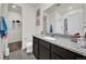 Bathroom features a granite countertop, white sink, and large mirror at 7433 Ellingwood Cir, Frederick, CO 80504