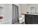 Neutral bathroom with a shower-tub combo, modern fixtures, and a granite sink at 7433 Ellingwood Cir, Frederick, CO 80504