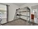 Cozy bedroom with gray carpeted floors and a loft bed, perfect for or guests at 7433 Ellingwood Cir, Frederick, CO 80504