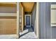 Home entryway featuring a covered porch and a 'HOME' sign by the garage at 7433 Ellingwood Cir, Frederick, CO 80504
